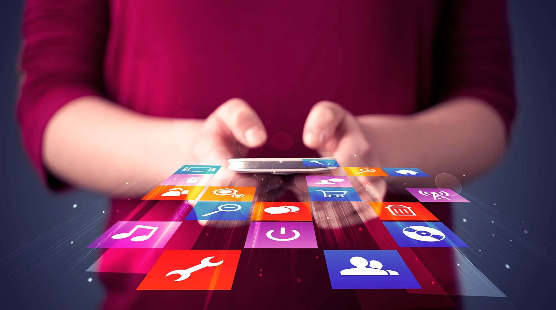 Woman holding smart phone with colorful application icons